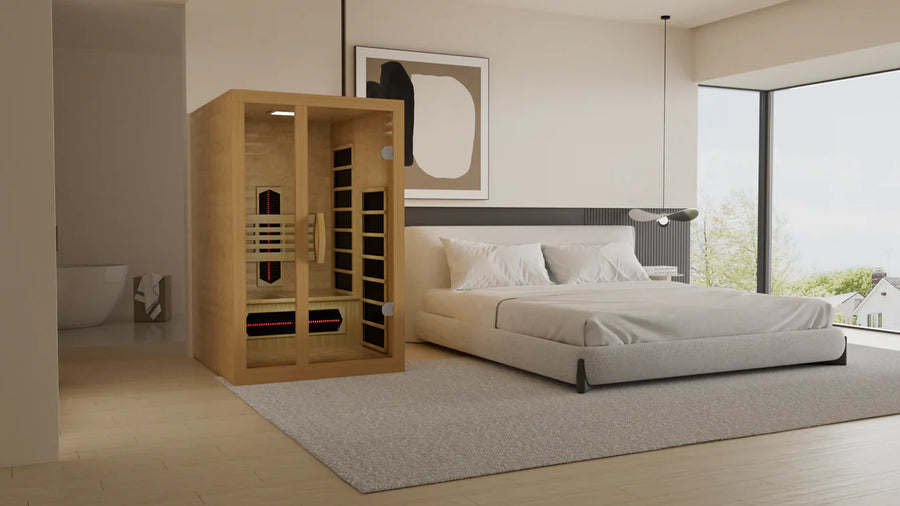 A modern bedroom features a large bed, minimalist decor, floor-to-ceiling windows, and a Golden Designs Dynamic Gracia 1-2-Person Full Spectrum Near Zero EMF FAR IR Sauna (DYN-6119-03 FS) placed in the corner on a light gray carpet.