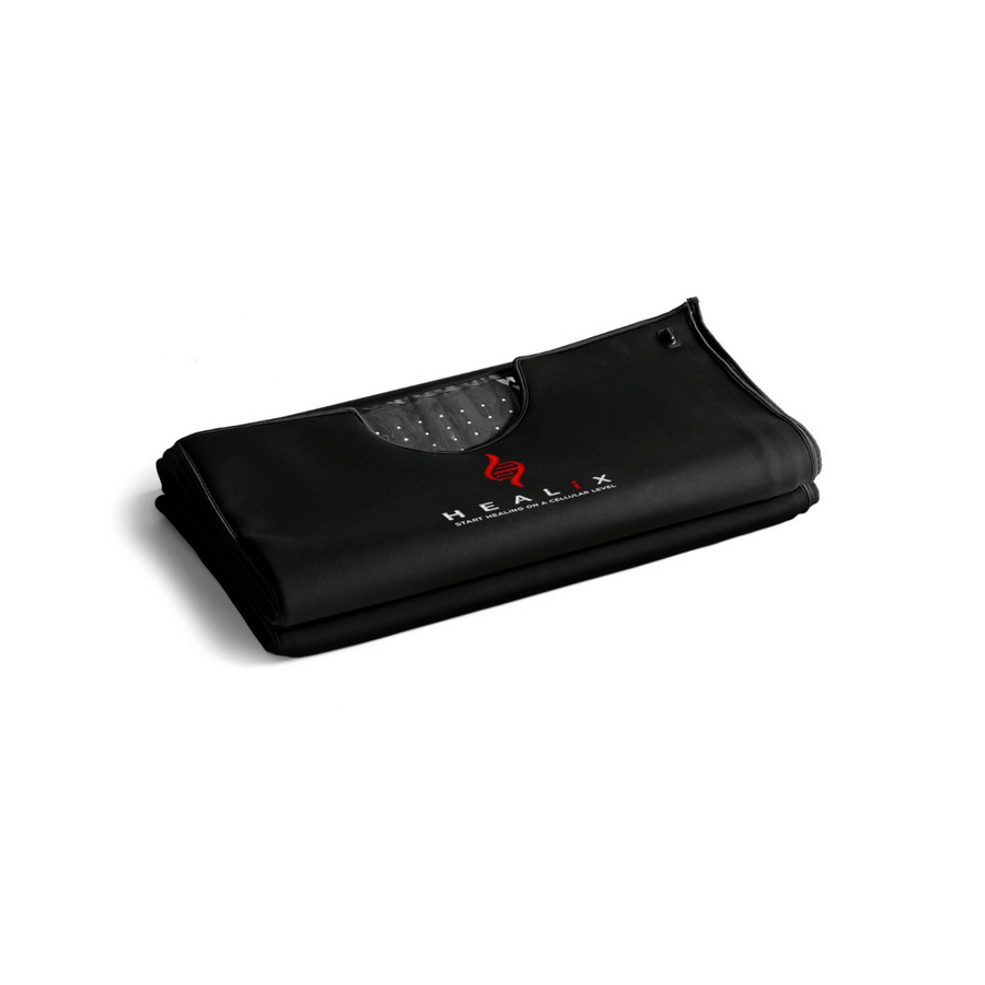 A folded black HEALiX Infrared Glow Pod, a versatile wellness device, features a visible gray dotted inner lining and “HEALIX” branding in white and red on the front, set against a white background.