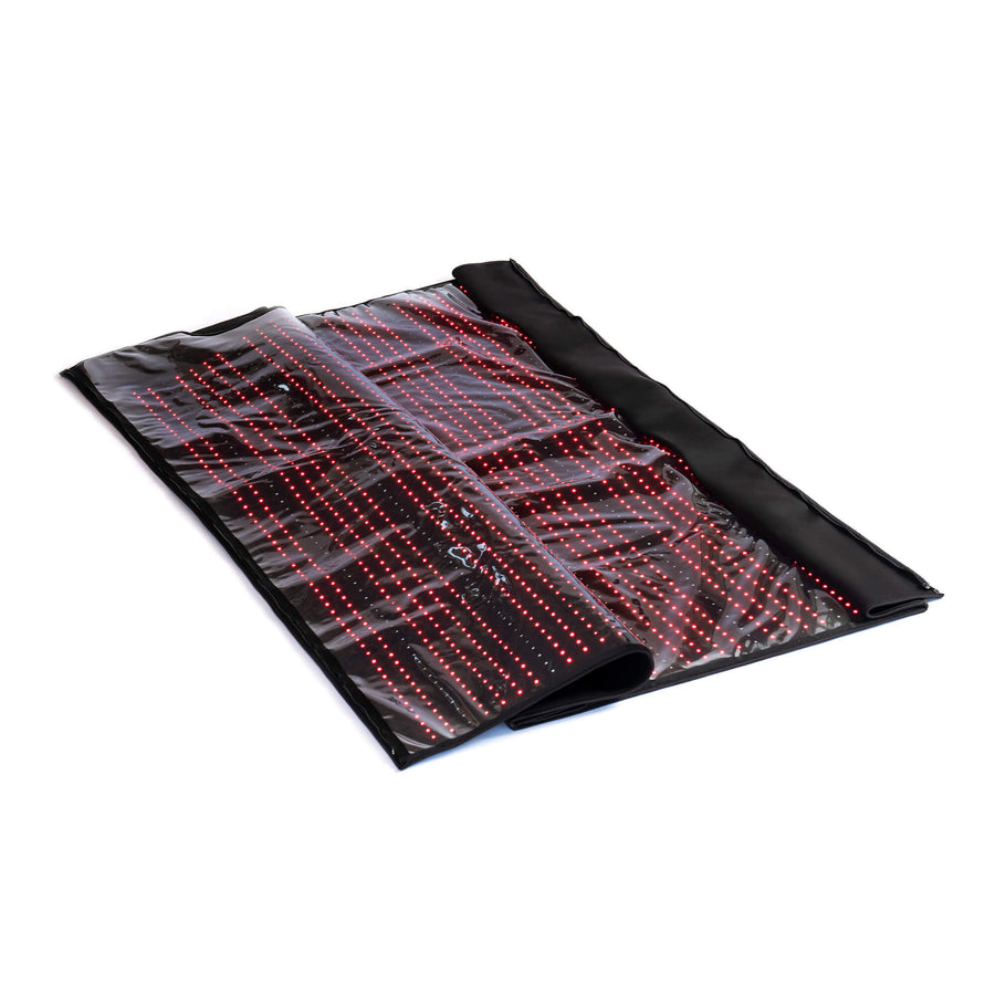 The HEALiX Glow Pod by HEALiX Infrared is a flexible black wellness mat with rows of small red LED lights for red light and near infrared therapy, visible under a clear cover and shown partially rolled on a white background.