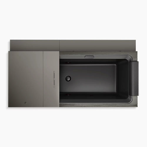 Top view of the Kohler x Remedy Place Ice Bath by Kohler—a modern rectangular black tub with a built-in headrest, surrounded by sleek gray panels, ideal for hydrotherapy or cold immersion with its minimalist, contemporary design.