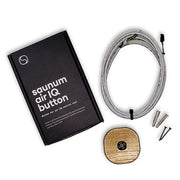 The Saunum AirIQ Button Set by Saunum includes a black box, coiled white cable, wall plugs and screws, and a compact wooden control with a fan icon for easy in-sauna and sauna fan operation.