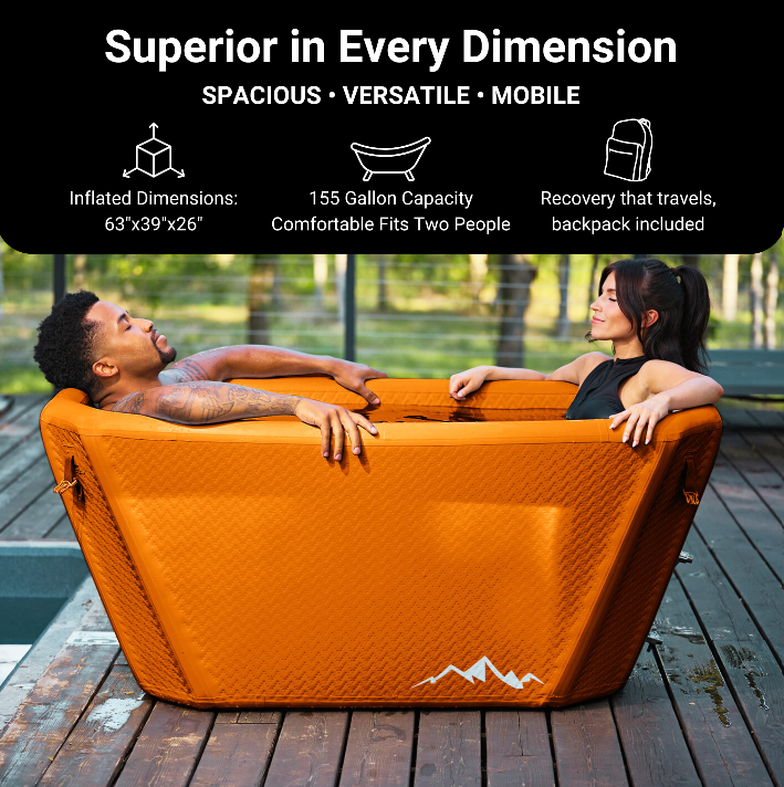 Two people relax in the orange Icebound Essentials Big Tex Endurance Plunge Tub on a wooden deck. This portable inflatable tub measures 63x39x26", holds 155 gallons for full-body immersion, and includes a backpack for easy transport.