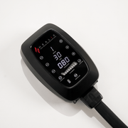 A black HEALiX Infrared Flow Pro Compression Boot control panel with a digital display (showing 30 and 080) and multiple buttons rests on a white surface—perfect for managing pneumatic therapy during recovery sessions.