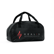 The HEALiX Flow duffel bag by HEALiX Infrared is black, with a red DNA strand graphic, the HEALiX logo, and the tagline "START HEALING ON A CELLULAR LEVEL" printed on the side.
