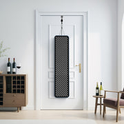 A RLT Home Total Spectrum MAX Red Light Therapy Panel from RLT Home hangs on a white door in a modern holistic wellness living room, alongside a wooden wine rack, bottles, and a small round table with chairs.