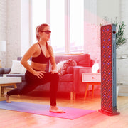 A woman in athletic wear does a lunge on a yoga mat in a bright living room, facing the RLT Home Total Spectrum MAX Red Light Therapy Panel, which emits red and blue lights for skin restoration.
