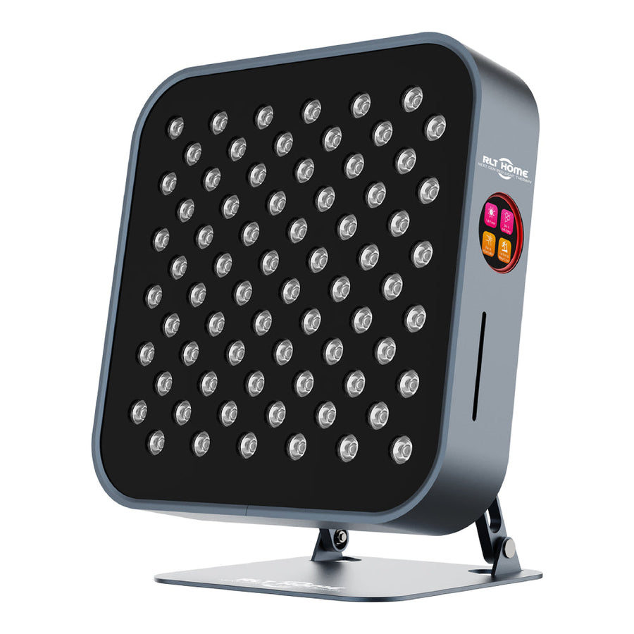 The RLT Home Total Spectrum MINI Red Light Therapy Panel by RLT Home features a modern rectangular design with multiple small LEDs, a sleek gray frame, and a digital control panel with pink, orange, and yellow buttons on the right. It’s stand-mounted for easy home wellness use.