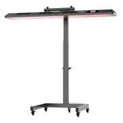 The RLT Home Total Spectrum ULTRA (7 Wave 480 LEDs) is a black, adjustable-height infrared therapy lamp on wheels, with a wide rectangular red light panel and top control buttons for skin rejuvenation and full-body wellness.