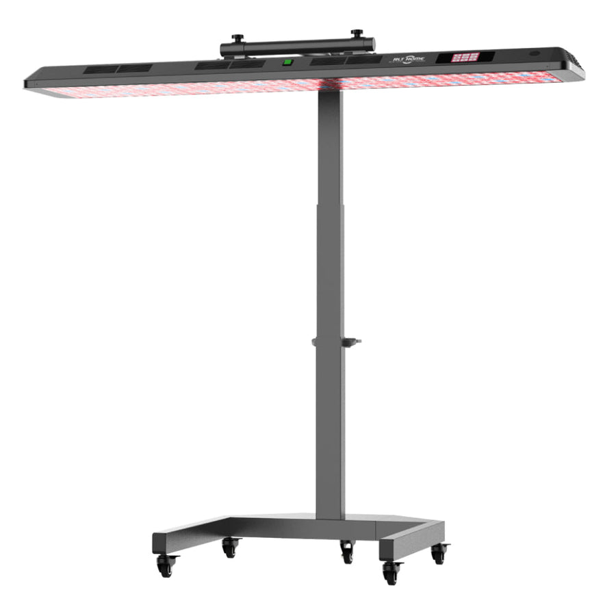 The RLT Home Total Spectrum ULTRA (7 Wave 480 LEDs) is a black, adjustable-height infrared therapy lamp on wheels, with a wide rectangular red light panel and top control buttons for skin rejuvenation and full-body wellness.