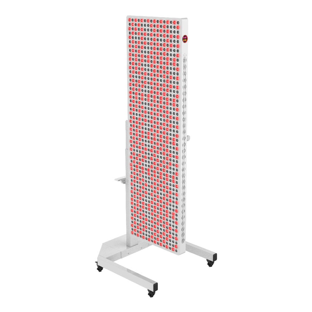 The RLT Home Total Spectrum ELITE (7 Wave 864 LEDs) is a tall, white red light therapy device on wheels with rows of illuminated red lights, designed for full-body therapy or medical treatments and standing on a sturdy base.
