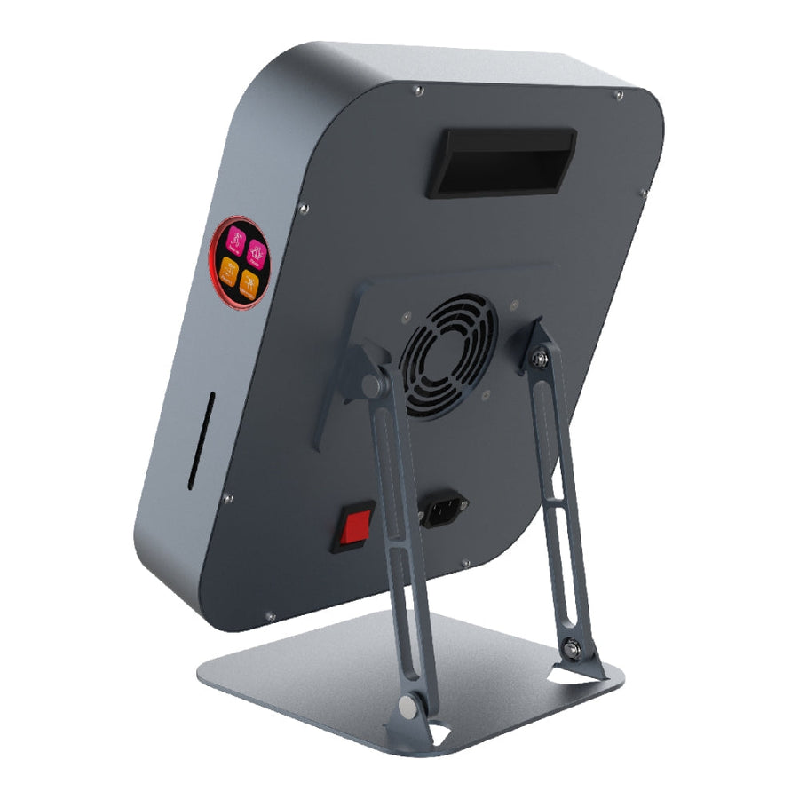 The RLT Home Total Spectrum MINI (7 Wave 72 LEDs) is a square silver wellness device with rounded edges on a metal base. With a cooling fan, power switch, buttons, ports, and top screen on the back, it’s ideal for targeted pain relief.