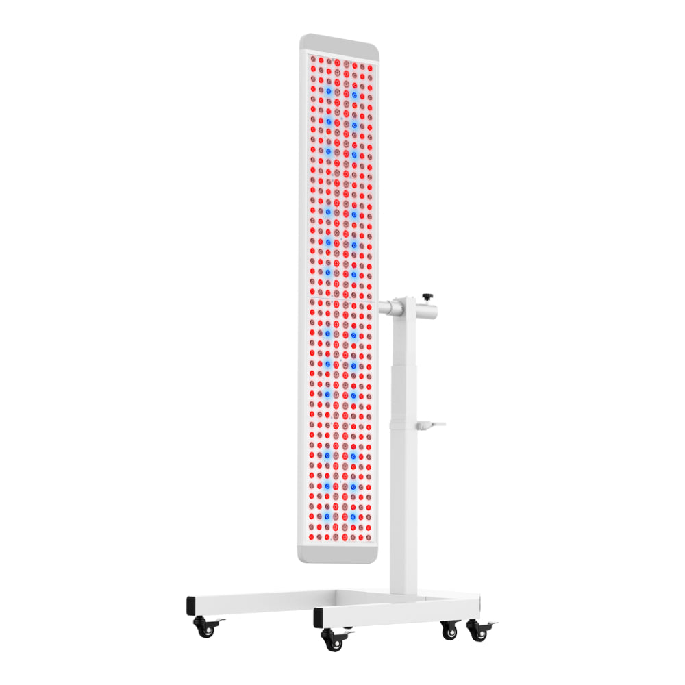 The RLT Home Total Spectrum ULTRA (7 Wave 480 LEDs) is a tall, rectangular red and near-infrared light therapy panel on a white wheeled stand with rows of red and blue LEDs for full-body wellness and pain relief.