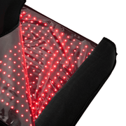 Close-up of the HEALiX Infrared Elevate Light Pod: a black mat with a transparent section showing a grid of glowing red LED lights, designed for red light and near-infrared therapy to provide targeted pain relief.
