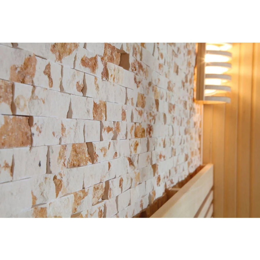 A close-up of a textured stone wall beside a wooden panel wall with a modern layered light creates an inviting backdrop for the SunRay Westlake 3 Person Indoor Traditional Sauna 300LX by SunRay.