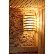 The wall-mounted wooden sauna light softly illuminates the textured stone and wood panels, enhancing the inviting atmosphere of your SunRay Westlake 3 Person Indoor Traditional Sauna 300LX for a cozy home retreat.