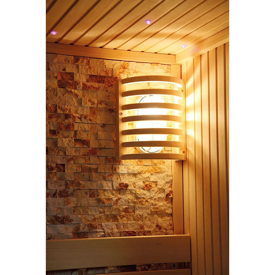 The wall-mounted wooden sauna light softly illuminates the textured stone and wood panels, enhancing the inviting atmosphere of your SunRay Westlake 3 Person Indoor Traditional Sauna 300LX for a cozy home retreat.