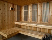 Almost Heaven Bridgeport 6 Person Indoor Hybrid Sauna with multi-level benches and Harvia 8kW electric heater; fits in basement, home gym, or bathroom; brands such as Dynamic, Osaki, Titan, Golden Designs, Maxxus.