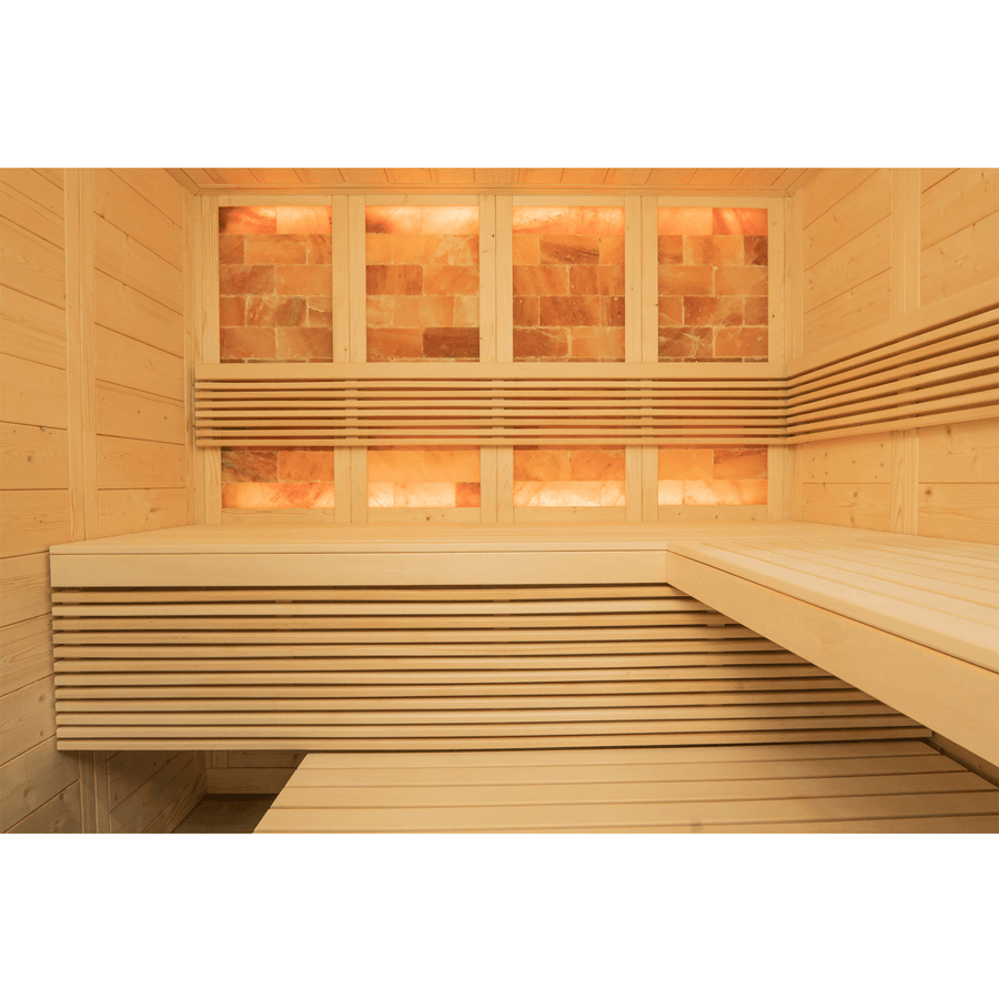 The Almost Heaven Himalaya 4 Person Indoor Sauna by Almost Heaven features light wood benches and walls with illuminated Himalayan salt bricks on the back wall, providing a relaxing salt therapy experience.