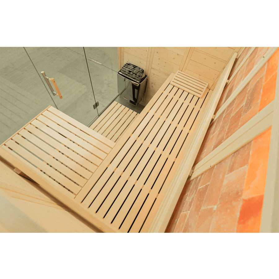 The Almost Heaven Himalaya 4 Person Indoor Sauna by Almost Heaven features wooden benches, a compact electric heater, a glass door, light wood walls, and reddish-orange Himalayan salt bricks for soothing salt therapy.