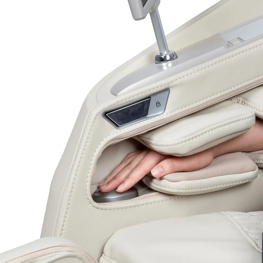 A hand rests on the round control knob inside the cream-colored leather armrest of the Osaki Ai series Apex Duo 5D+4D massage chair, surrounded by cushioned padding and a lock button above.