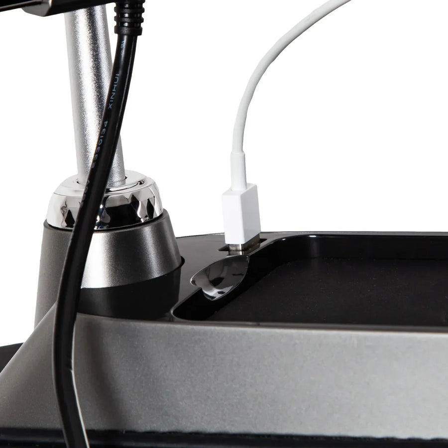 Close-up of two cables—one with a black connector and one with a white connector—plugged into an Osaki 4D+3D Bravo Duo Flex massage chair against a plain background.