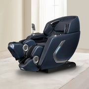 The Osaki 4D+3D Bravo Duo Flex massage chair in dark blue with built-in controls and speakers rests on a light rug in a bright room with large windows and beige walls.