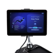 A tablet mounted on a stand displays the Osaki 4D+3D Bravo Duo Flex massage chair controls, showing a Deep Tissue massage with 29:49 left, intensity settings, and a diagram of massage zones.