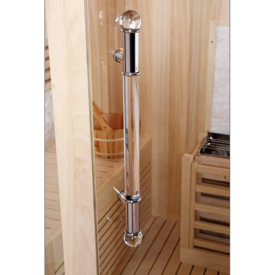 A glass sauna door with a vertical metal handle is set in the wood interior of the SunRay Westlake 3 Person Indoor Traditional Sauna 300LX, featuring benches and a heater—ideal for relaxing at home.