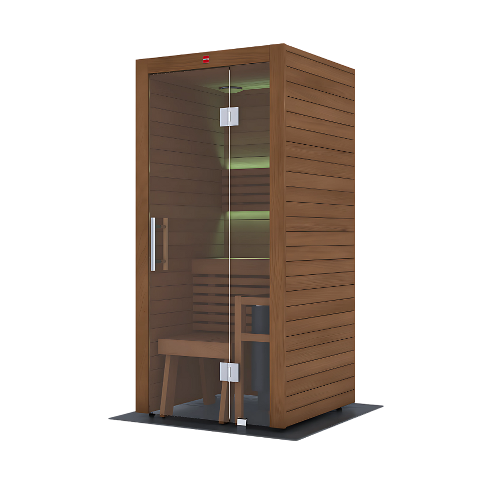 The LuxeWell Life Harvia Utu, a heat-treated 1-person indoor sauna, features Nordic spruce with horizontal slats, a glass door, wooden bench, and soft green LED lighting on the back wall. It stands on a dark mat against a plain white background.