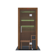 The LuxeWell Life Harvia Utu is a heat-treated Nordic spruce 1-person indoor sauna with a glass door, bench, stool, and green LED lighting—shown from the front against a plain white background.