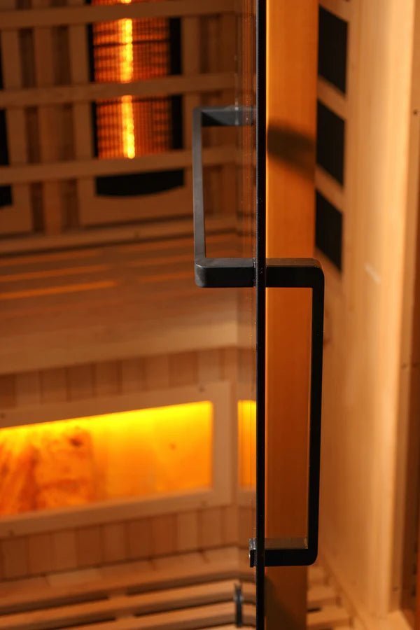 Close-up of a Golden Designs Reserve Edition GDI-8040-03 Full Spectrum sauna door handle in Canadian Hemlock wood with Himalayan Salt Bar.