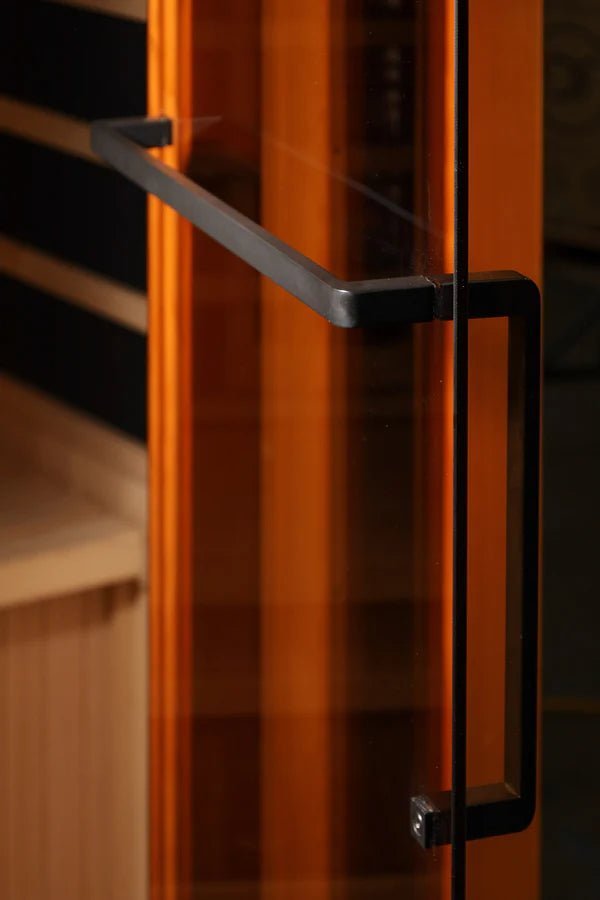 Close-up of the Golden Designs Reserve Edition GDI-8040-03 Full Spectrum sauna's tempered glass door with a black handle.