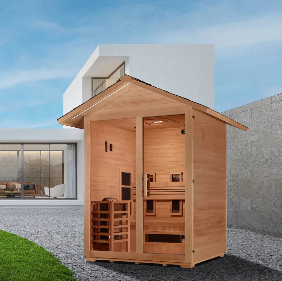 Golden Designs Carinthia 3 Person Hybrid Outdoor Sauna - Canadian Hemlock, featuring a wooden structure with glass door, roof, and outdoor seating.