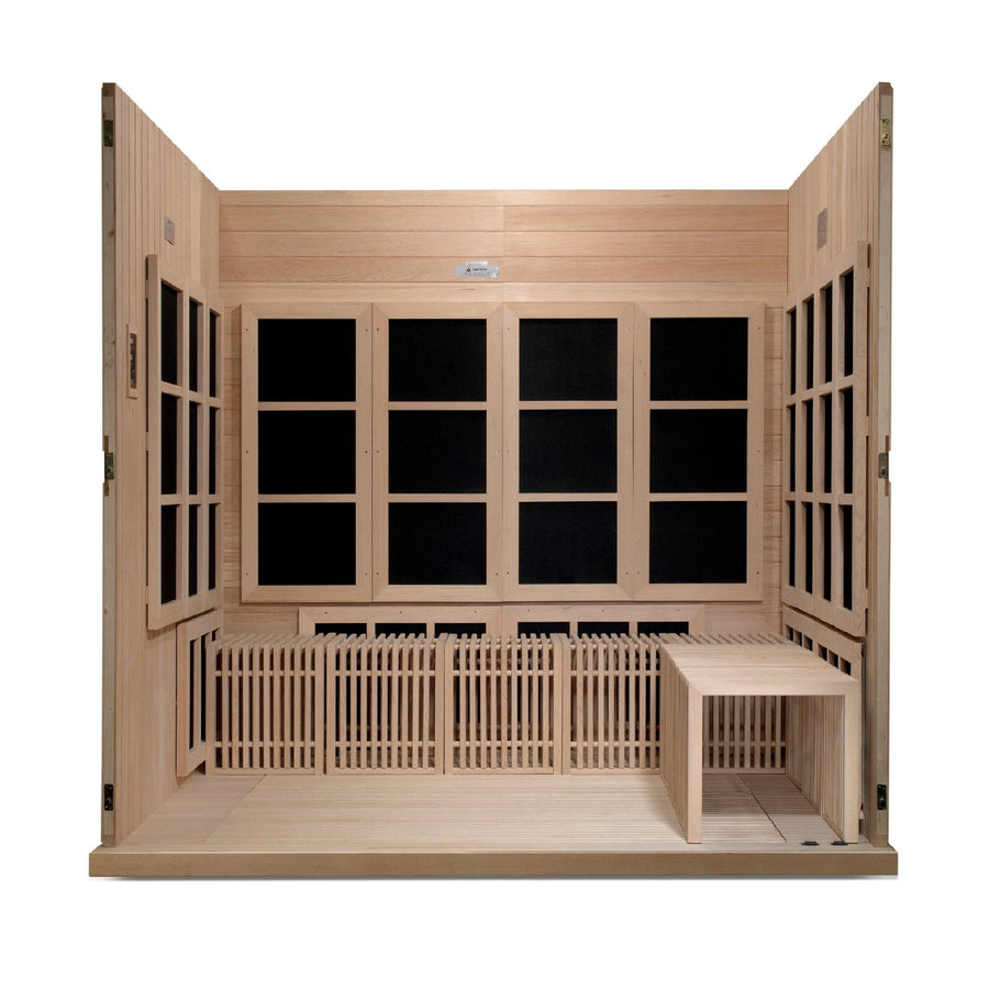 Golden Designs Catalonia 8 Person Ultra Low EMF FAR Infrared Sauna in a wooden room with windows and bench, showcasing its spacious, wheelchair-accessible design and high-quality Canadian Hemlock construction.