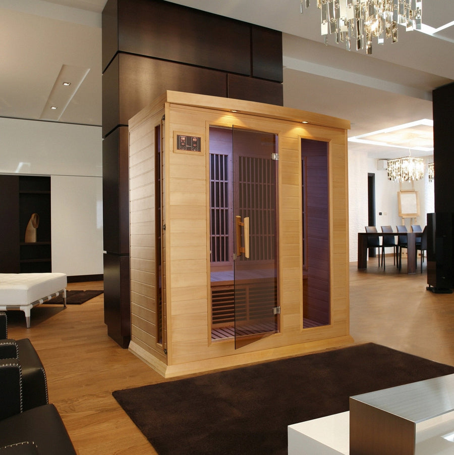 Maxxus 3 Person Low EMF FAR Infrared Sauna Canadian Hemlock with glass doors, interior lighting, and control panels, showcased in a modern room setting.