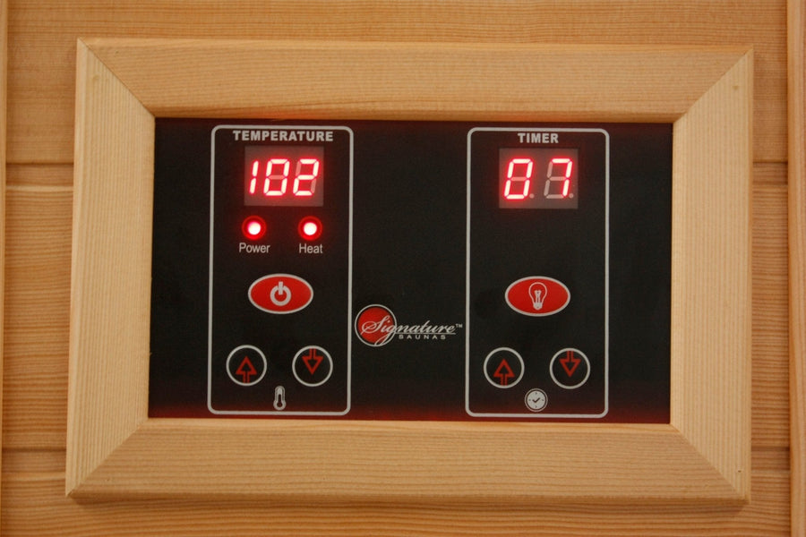 Close-up of Maxxus 3 Person Low EMF FAR Corner Infrared Sauna Canadian Red Cedar with touch screen control panel and digital clock display.
