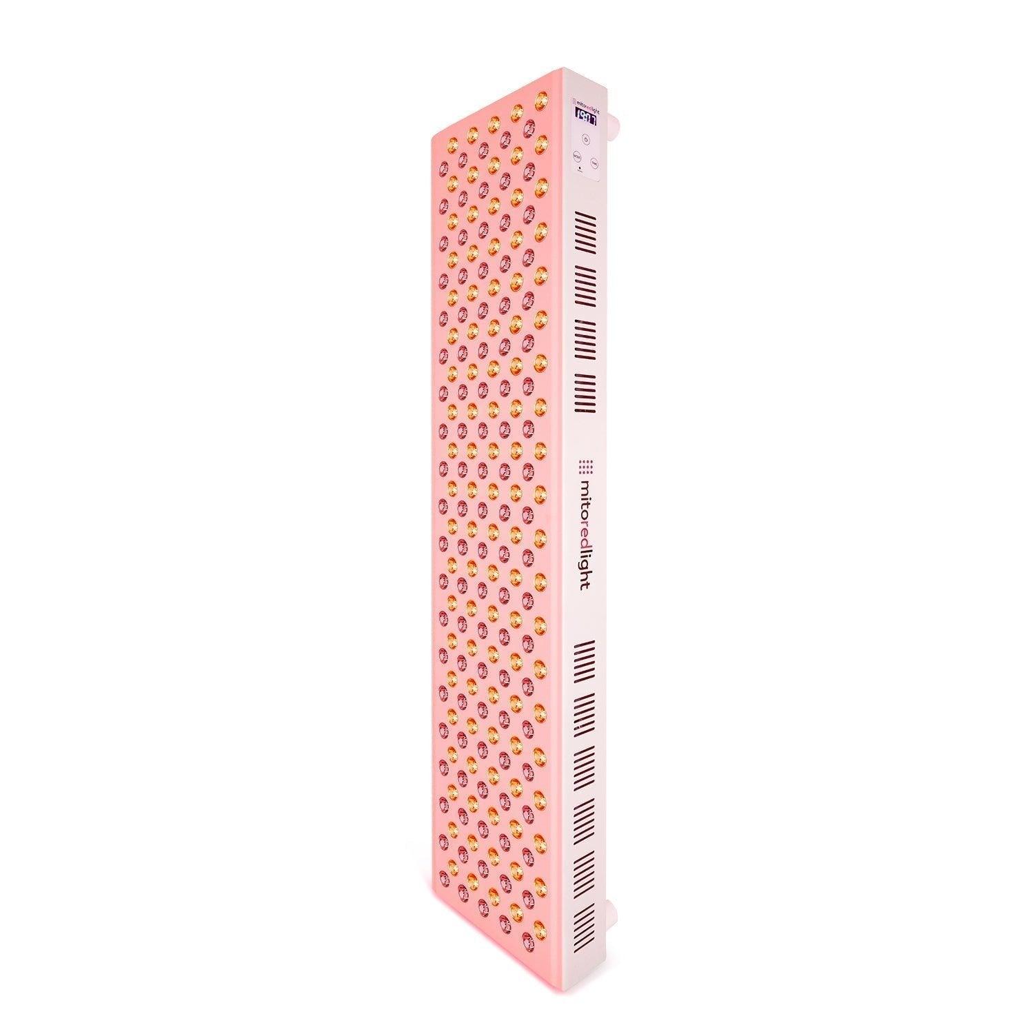 The Mito Red Light MitoMAX 2.0 is a tall, rectangular pink red light therapy panel featuring rows of small circular lights on the front and side ventilation slots, shown standing upright against a white background.