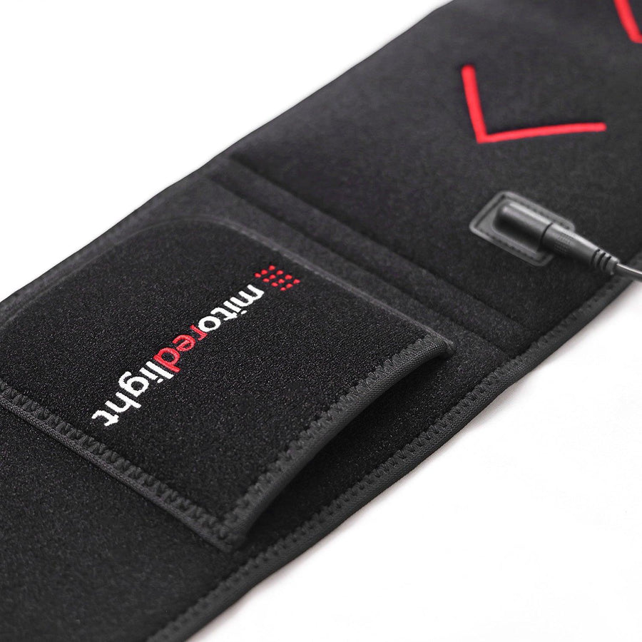 A close-up of the MitoQUAD™ Wavelength Belt by Mito Red Light, a black hands-free red light therapy device with TriChip tech, mitoredlight pocket label, red accents, and a black power cord—ideal for medical grade use.