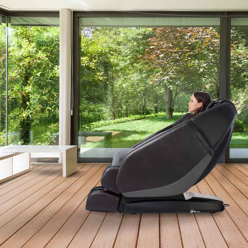 A woman relaxes in a Daiwa Orbit 3D Massage Chair, showcasing its advanced features and space-saving design.