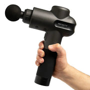 A hand holding the Infinity PR Pro Endurance Percussion Massage Device, showcasing its ergonomic design and portable size.