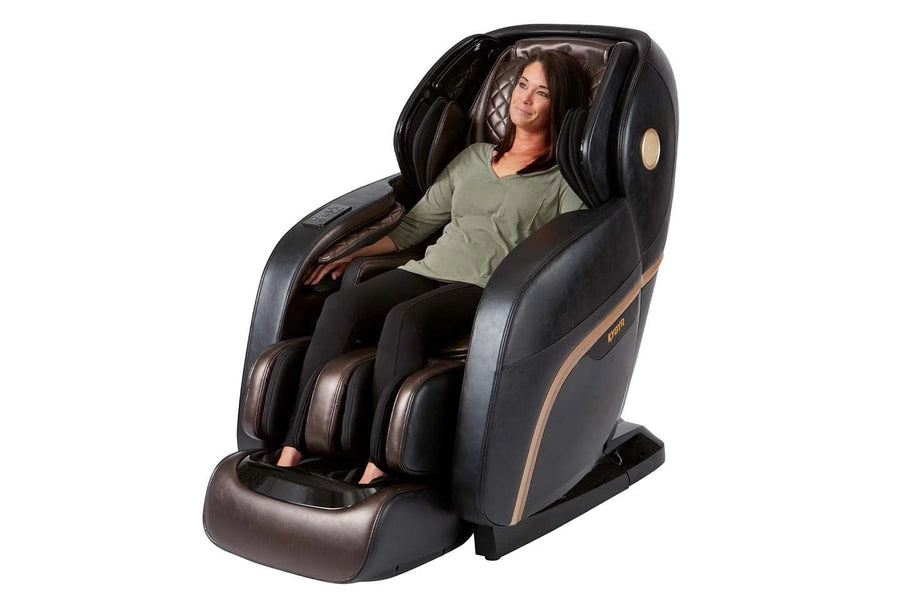 A woman relaxing in the Kyota Kokoro M888 4D massage chair, showcasing its advanced massage technology and ergonomic design.