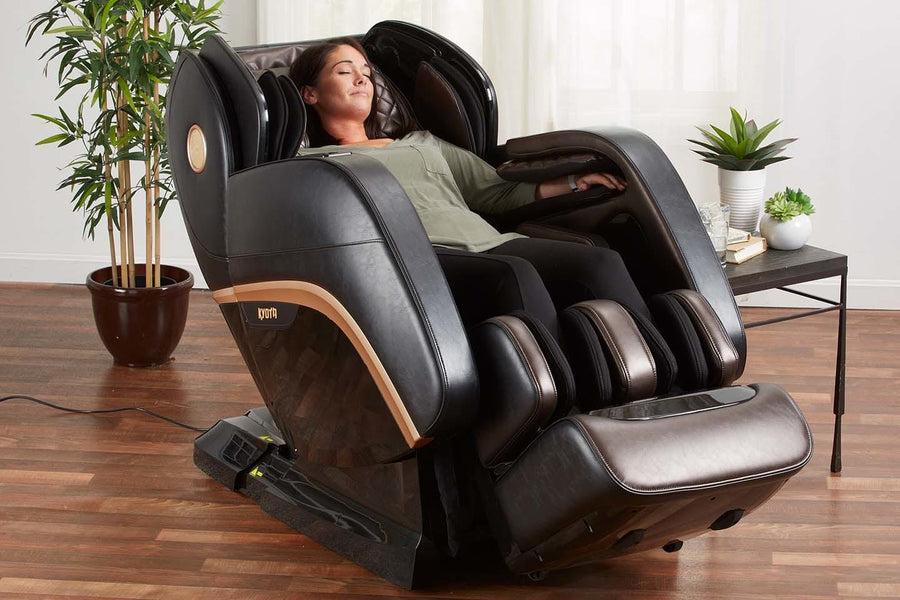 A woman lying in a Kyota Kokoro M888 Massage Chair, showcasing its advanced massage technology and comfort features.