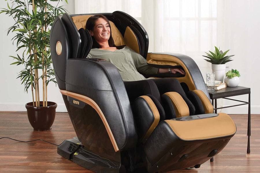 A woman sits in the Kyota Kokoro M888 Massage Chair, enjoying its advanced 4D Back Mechanism and J-Track design for full-body relief.